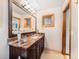 Bathroom with marble countertops, sleek fixtures and custom mirror at 62 N Ranch Rd, Littleton, CO 80127