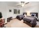 Comfortable bedroom with two twin beds, neutral walls, and a ceiling fan at 62 N Ranch Rd, Littleton, CO 80127