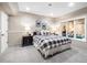 Finished basement bedroom with a large window and bedside tables with lamps at 62 N Ranch Rd, Littleton, CO 80127