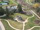 Aerial view of community park featuring playground, garden plots, and walking trails at 62 N Ranch Rd, Littleton, CO 80127
