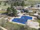 Aerial view of a community pool, clubhouse, and surrounding landscape at 62 N Ranch Rd, Littleton, CO 80127