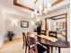 Open dining room with a modern chandelier, a spacious table, and seamless access to other living areas at 62 N Ranch Rd, Littleton, CO 80127