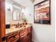 Half bath with granite countertop, vessel sink, framed mirror, and decorative accents at 62 N Ranch Rd, Littleton, CO 80127