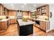 Gourmet kitchen featuring custom wood cabinets, stainless steel appliances, and a large center island at 62 N Ranch Rd, Littleton, CO 80127