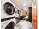 Laundry room boasts modern appliances, a sink, and ample storage space for added convenience at 62 N Ranch Rd, Littleton, CO 80127