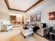 Comfortable living room featuring plush seating, tray ceiling, and an open entryway at 62 N Ranch Rd, Littleton, CO 80127