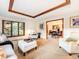 Bright living room with decorative tray ceiling, large window, and open access to the dining room at 62 N Ranch Rd, Littleton, CO 80127