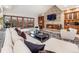 Inviting living room with stone fireplace, custom cabinets and a large window with natural light at 62 N Ranch Rd, Littleton, CO 80127