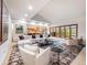 Bright and airy living room boasting ample seating, large windows, and seamless flow into the adjacent kitchen at 62 N Ranch Rd, Littleton, CO 80127
