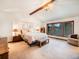 Spacious main bedroom featuring vaulted ceilings, a large window, and neutral decor at 62 N Ranch Rd, Littleton, CO 80127