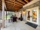 Cozy covered patio with comfortable seating, neutral decor, ceiling beams, and easy access to backyard at 62 N Ranch Rd, Littleton, CO 80127