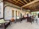 Inviting covered patio features comfortable wicker furniture, neutral decor, and an exposed wood ceiling at 62 N Ranch Rd, Littleton, CO 80127