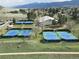 Aerial view of tennis courts surrounded by trees and a scenic landscape at 62 N Ranch Rd, Littleton, CO 80127