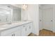 Bright bathroom featuring a double vanity and a shower behind a glass door at 9293 Biscay St, Commerce City, CO 80022