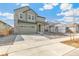 Charming two-story home with a two car garage, a stone chimney, and beautiful landscaping at 9293 Biscay St, Commerce City, CO 80022