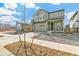Two-story home with green siding, a stone chimney accent, and an attached two-car garage at 9293 Biscay St, Commerce City, CO 80022
