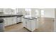 Modern kitchen island with stainless steel appliances and light-filled breakfast nook at 9293 Biscay St, Commerce City, CO 80022
