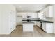 Well-lit kitchen with white cabinets, stainless steel appliances, a center island, and modern finishes at 9293 Biscay St, Commerce City, CO 80022