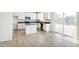 Modern kitchen boasts white cabinetry, stainless steel appliances, and a center island for prep and dining at 9293 Biscay St, Commerce City, CO 80022