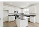Stylish kitchen with white cabinetry, stainless appliances, a center island and sleek countertops and backsplash at 9293 Biscay St, Commerce City, CO 80022