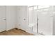 Bright bathroom featuring a tile shower with bench seating behind glass doors at 9293 Biscay St, Commerce City, CO 80022