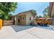 Backyard concrete patio area with outdoor furniture, mature trees, and privacy fence at 915 N Kearney St, Denver, CO 80220