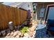 Secluded backyard pond featuring a small waterfall, landscaping rocks, and privacy fence at 915 N Kearney St, Denver, CO 80220