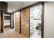 View of stylish bathroom adjacent to a room with sliding barn doors and neutral decor at 915 N Kearney St, Denver, CO 80220