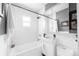 Modern bathroom with white subway tile, a sleek sink, and a combined tub and shower at 915 N Kearney St, Denver, CO 80220
