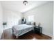 Bright bedroom with hardwood floors, a comfortable bed, and ample natural light at 915 N Kearney St, Denver, CO 80220