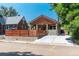 Charming bungalow with a modern horizontal wood fence and a freshly poured concrete driveway at 915 N Kearney St, Denver, CO 80220