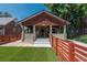 Inviting bungalow with manicured lawn, stone columns, and horizontal wood fence at 915 N Kearney St, Denver, CO 80220