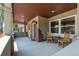 Charming front porch with wooden chairs, exposed brick accents, and stylish columns at 915 N Kearney St, Denver, CO 80220