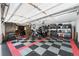 Spacious garage with checkered tile floor and ample storage, featuring three motorcycles at 915 N Kearney St, Denver, CO 80220
