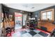 Finished garage space with an office, artwork, seating, and a patio just beyond the sliding glass door at 915 N Kearney St, Denver, CO 80220