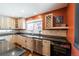 Well-lit kitchen with stainless steel appliances, ample counter space, and a built-in wine fridge at 915 N Kearney St, Denver, CO 80220