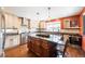 Spacious kitchen featuring granite counters, stainless steel appliances, and a central island at 915 N Kearney St, Denver, CO 80220