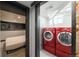 Neat laundry room with red washer/dryer next to bedroom featuring gray trim at 915 N Kearney St, Denver, CO 80220