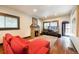 Comfortable living room featuring a stone fireplace, plush red seating, and hardwood floors at 915 N Kearney St, Denver, CO 80220