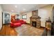 Inviting living room with a cozy stone fireplace and warm hardwood floors at 915 N Kearney St, Denver, CO 80220