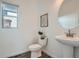 Clean half-bathroom with a pedestal sink, modern fixtures, and decorative accents at 15252 W 69Th Pl, Arvada, CO 80007