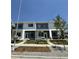 View of the townhome's facade, showcasing its modern architectural details and landscaping at 15252 W 69Th Pl, Arvada, CO 80007