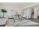 Inviting living space featuring neutral tones, stylish furniture, and a cozy rug at 15252 W 69Th Pl, Arvada, CO 80007