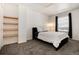 Bedroom features neutral walls and carpet with a shelving unit and bright window at 6240 Everett Ct # B, Arvada, CO 80004