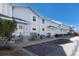 Row of light blue townhouses showcasing their inviting front entrances and dedicated parking at 6240 Everett Ct # B, Arvada, CO 80004