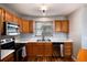 Well-lit kitchen with wood cabinets, stainless steel appliances, and modern countertops at 6240 Everett Ct # B, Arvada, CO 80004