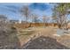 Fenced backyard with a small deck and mature trees, offering a private outdoor space at 805 Northridge Rd, Highlands Ranch, CO 80126
