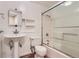 Bright bathroom features a pedestal sink, modern fixtures, and a glass-enclosed shower for a clean and contemporary look at 805 Northridge Rd, Highlands Ranch, CO 80126