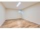 Minimalist bedroom with light hardwood flooring and a window, offering a blank canvas for customization and personalization at 805 Northridge Rd, Highlands Ranch, CO 80126