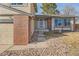 Inviting home entrance with brick accents, manicured landscaping, and a neatly paved walkway at 805 Northridge Rd, Highlands Ranch, CO 80126